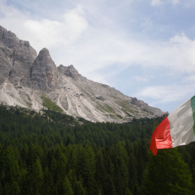 Italian flag under Dolomites